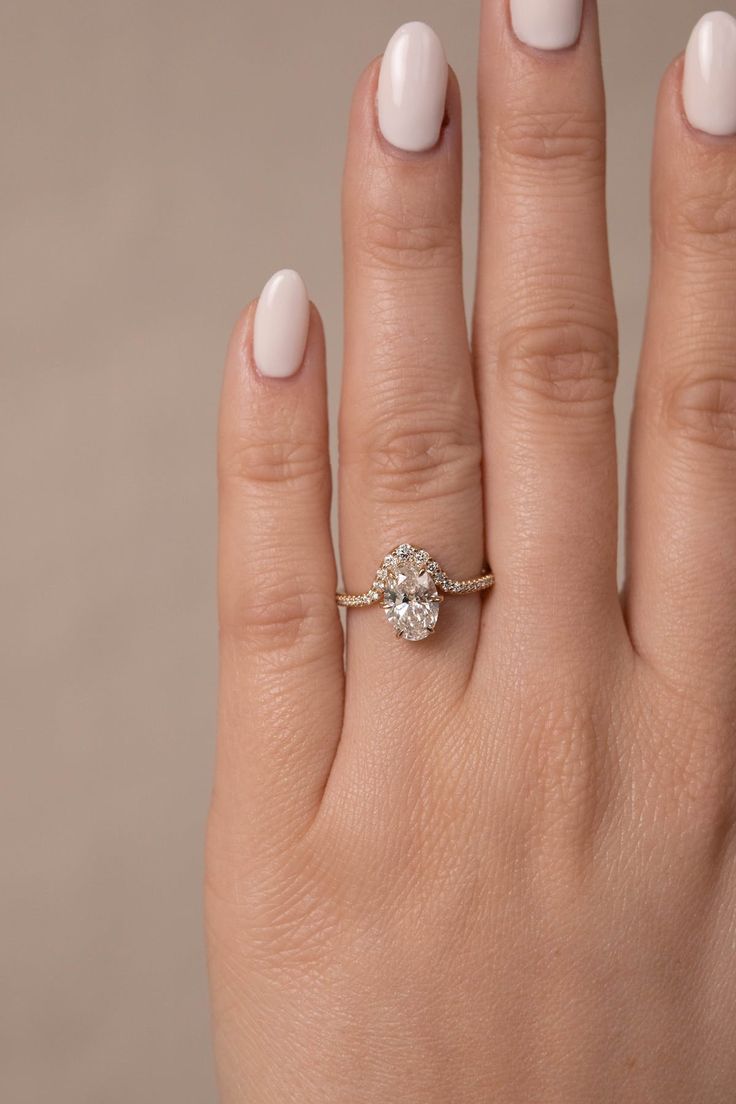 a woman's hand with a diamond ring on it