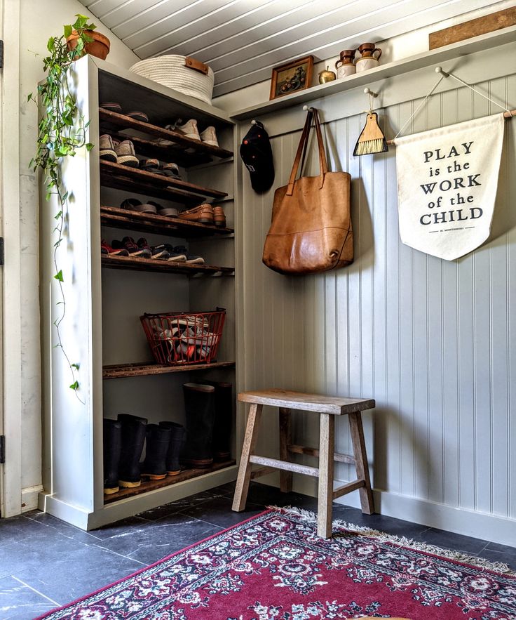 a wooden bench sitting next to a shelf filled with shoes and purses on top of it