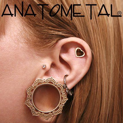 a close up of a person's ear with a pair of earrings on it