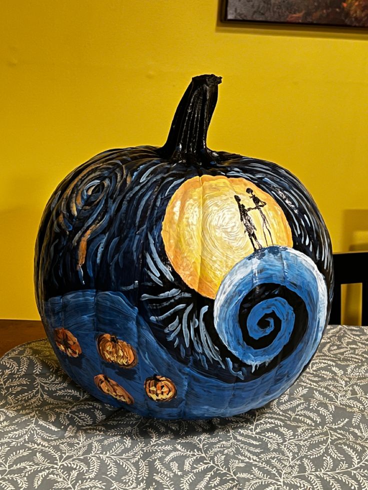 a painted pumpkin sitting on top of a table