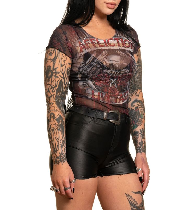 Affliction Women's Hollow Point Short Sleeve Baby Tee Black Poly Mesh Core Collection Black Skull Print Top For Biker Events, Edgy Short Sleeve Tops For Biker Events, Distressed Fitted Tops For Streetwear, Fitted Distressed Tops For Streetwear, Black Rocker Tops With Skull Print, Black Rocker Top With Skull Print, Black Rocker Style Top With Skull Print, Black Distressed Punk Tops, Black Distressed Festival Top