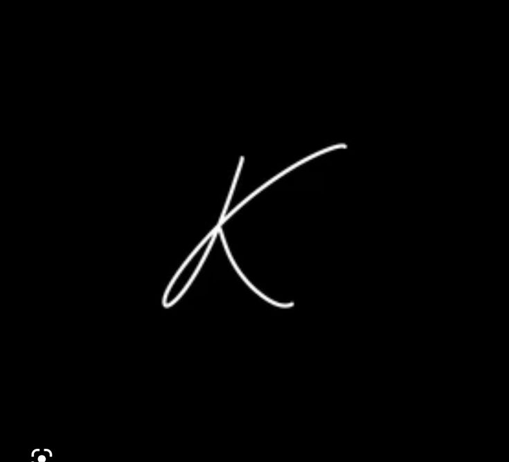 the letter k is written in white on a black background, and it appears to be cursive