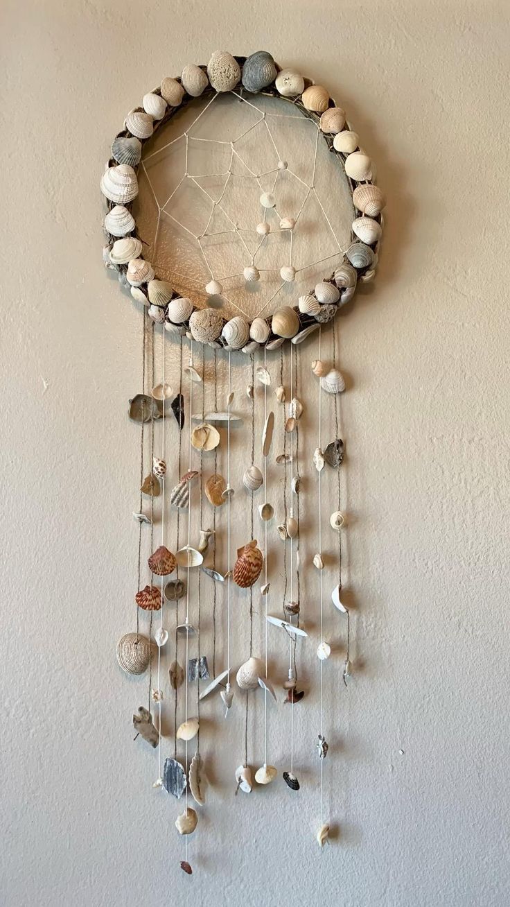 a wall hanging made out of rocks and shells