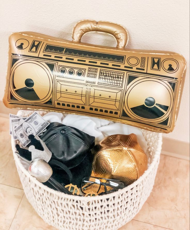 a white basket filled with assorted items on top of a tiled floor