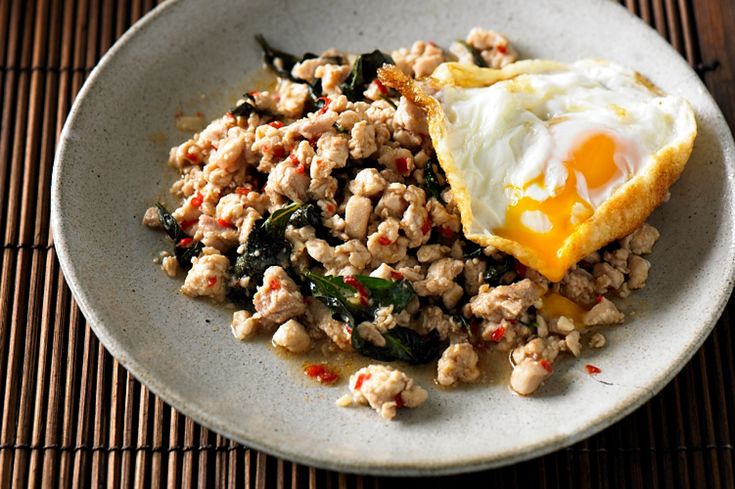 a white plate topped with rice and an egg