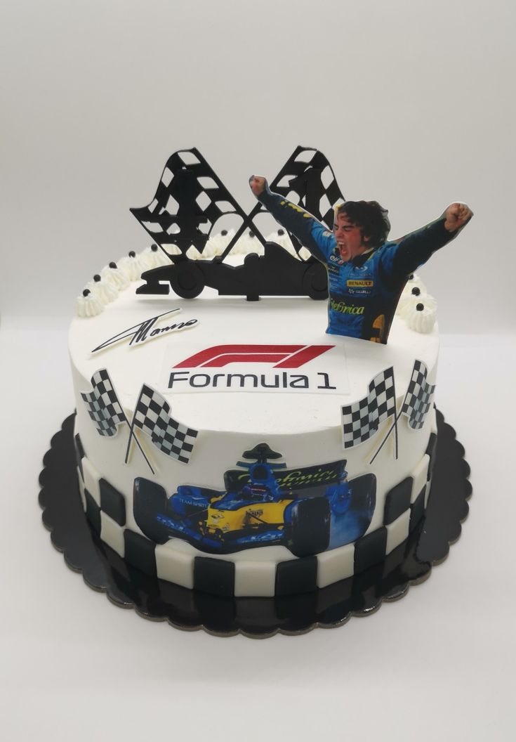 a cake with a man on top of it and a race car design on the side