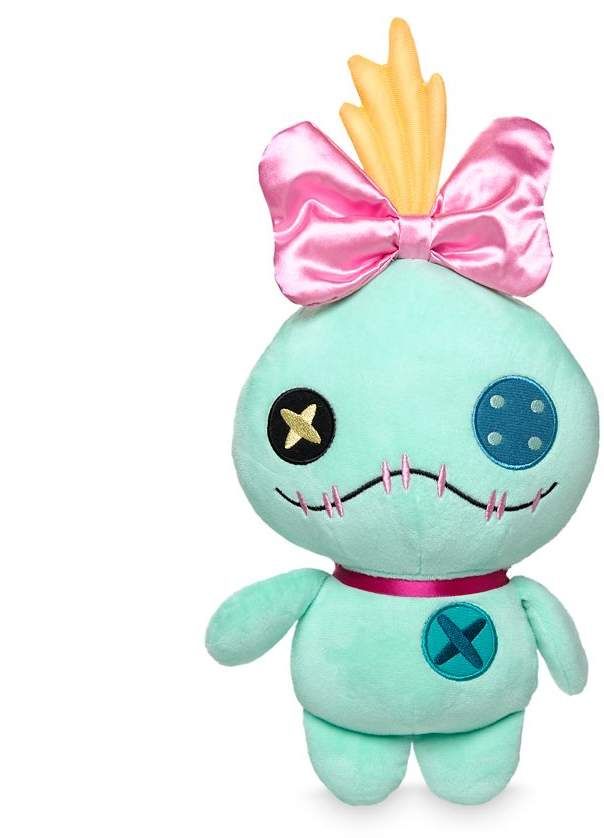 a green stuffed animal with a pink bow on it's head and big eyes