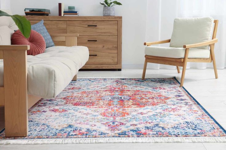 a living room with a couch, chair and rug