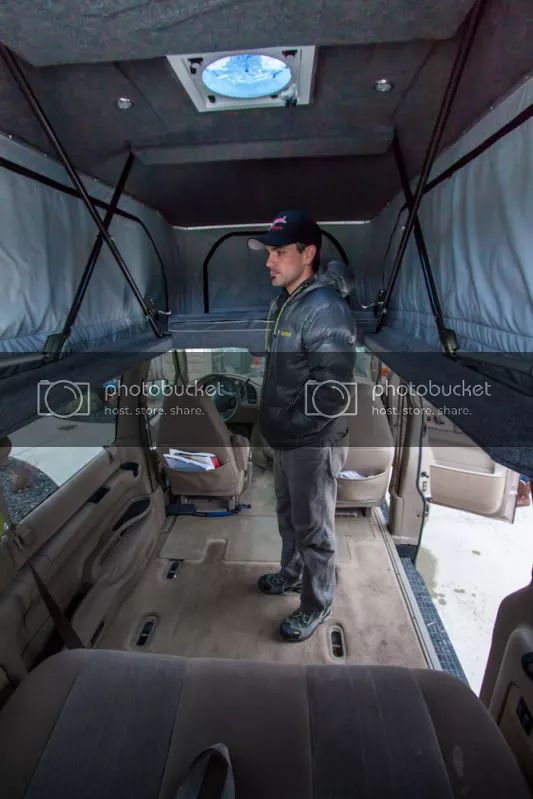 a man standing in the back of a truck