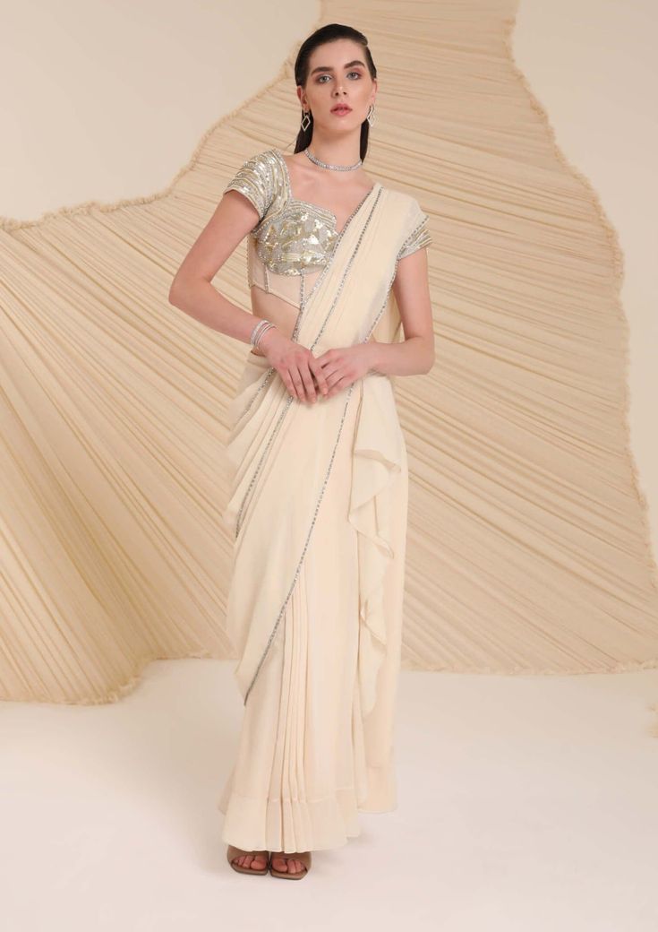 Festive Off White Pre-draped Saree, Pre-draped Georgette Lehenga For Designer Wear, Off White Traditional Drape Blouse Piece For Reception, Off White Blouse Piece For Reception With Traditional Drape, Off White Pre-draped Saree With Unstitched Blouse For Wedding, Festive Embellished Pre-draped Saree, Draped Georgette Choli For Reception, Draped Blouse With Zari Work For Wedding, Formal Pre-draped Saree With Zari Work