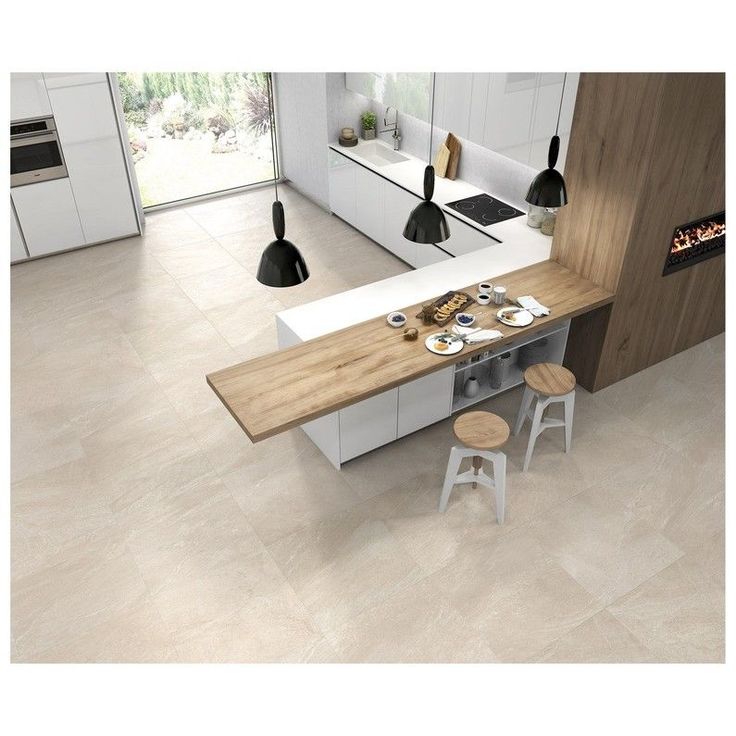 an aerial view of a modern kitchen and dining area with white cabinets, counter tops, and stools