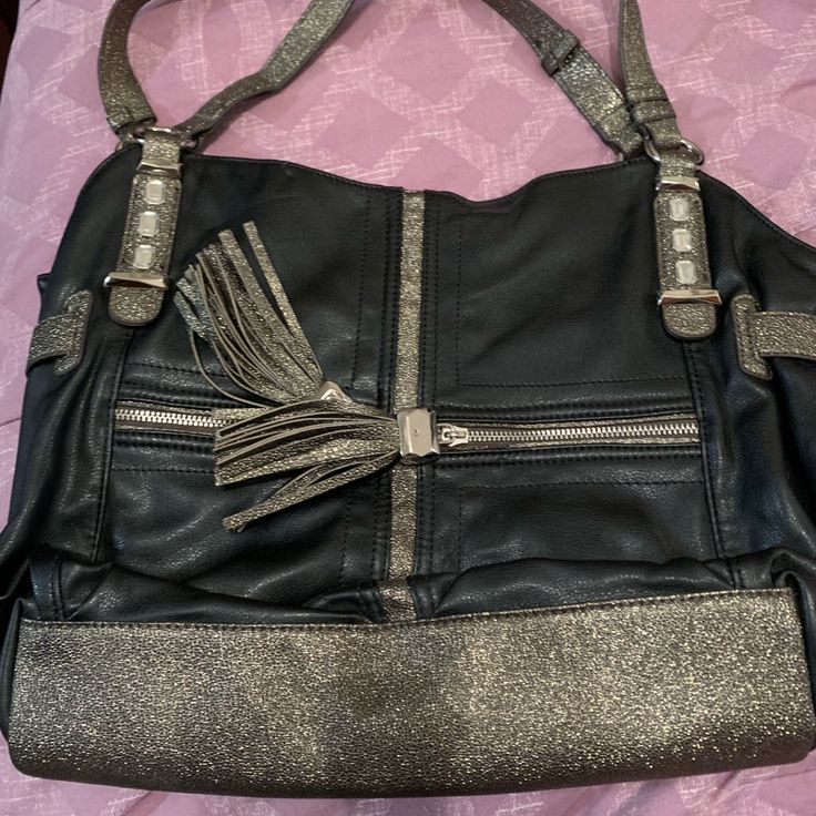 Like New, Never Used With No Markings Or Scratches On Bag. Comes With Two Zipper Compartments On The Front And Back. Great For Everyday Wear! Silver Leather Tote Satchel, Silver Leather Shoulder Satchel, Silver Satchel Shoulder Bag With Metal Hardware, Silver Soft Leather Travel Shoulder Bag, Silver Leather Satchel With Silver-tone Hardware, Silver Soft Leather Shoulder Bag For Travel, Black Shoulder Bag With Silver Accents For Everyday Use, Silver Leather Bag With Zipper Closure, Silver Leather Bags With Zipper Closure