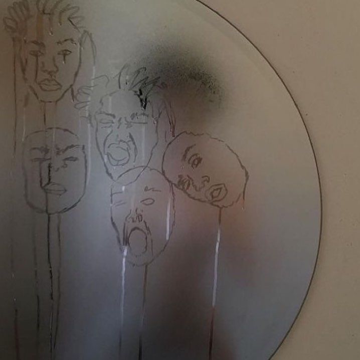 a mirror that has some drawings on it