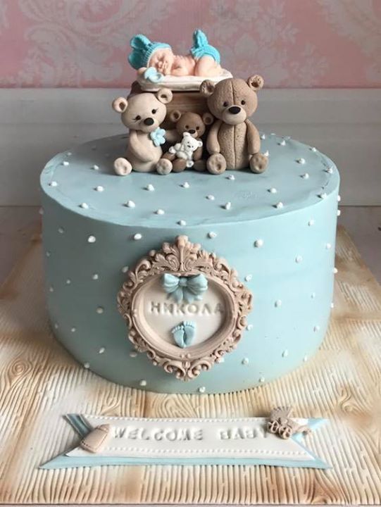 a blue cake with two teddy bears on top