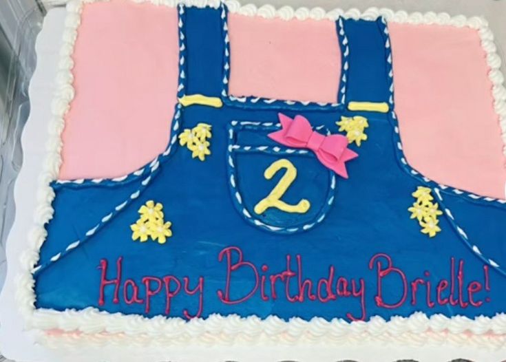 a birthday cake with the number twenty two in blue, pink and yellow on it