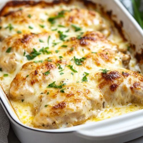 a casserole dish with chicken and cheese