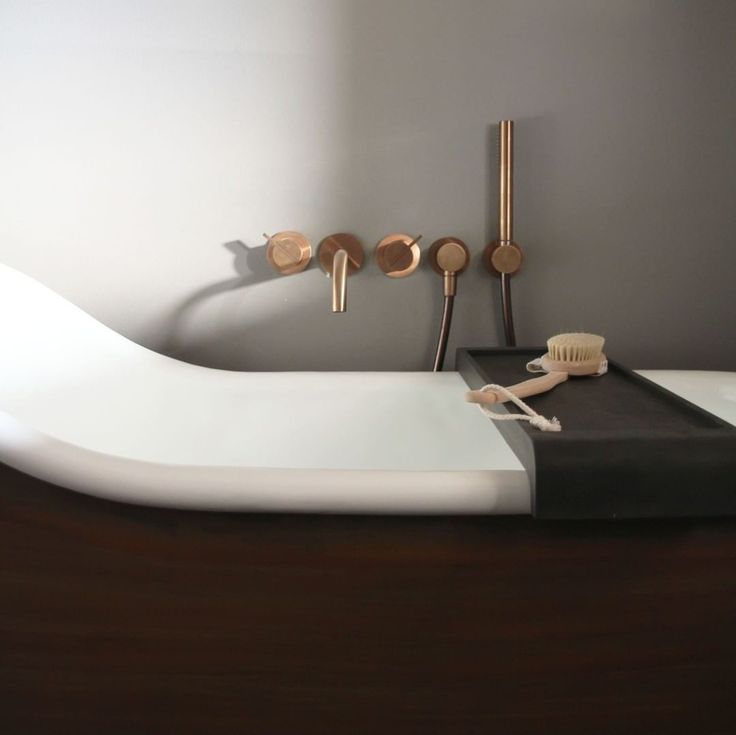 a bathroom sink with two toothbrushes and soap dispensers on it