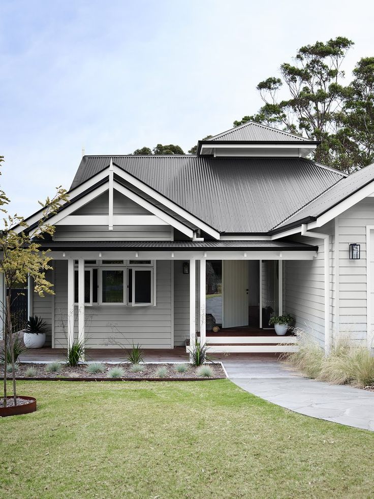 a grey house with white trim and gray roof