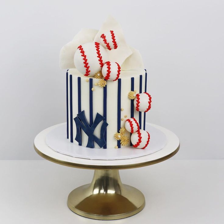 a baseball themed cake with red, white and blue icing on a gold plate