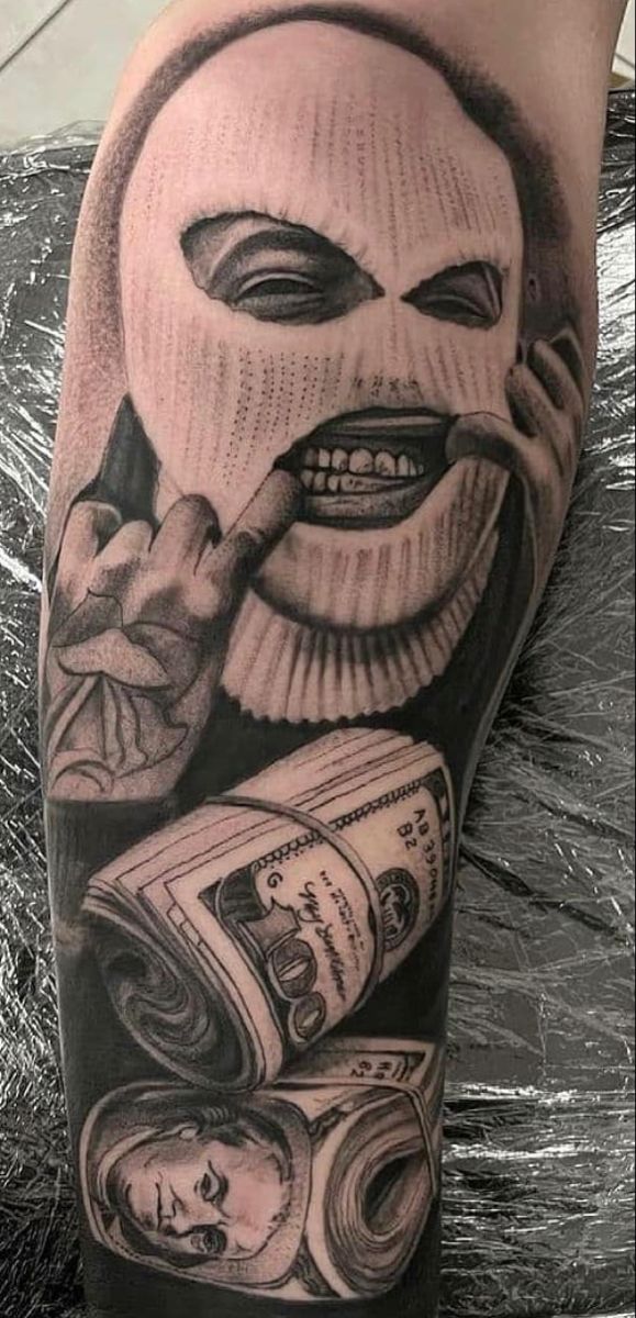 a man's arm with money and a mask on it