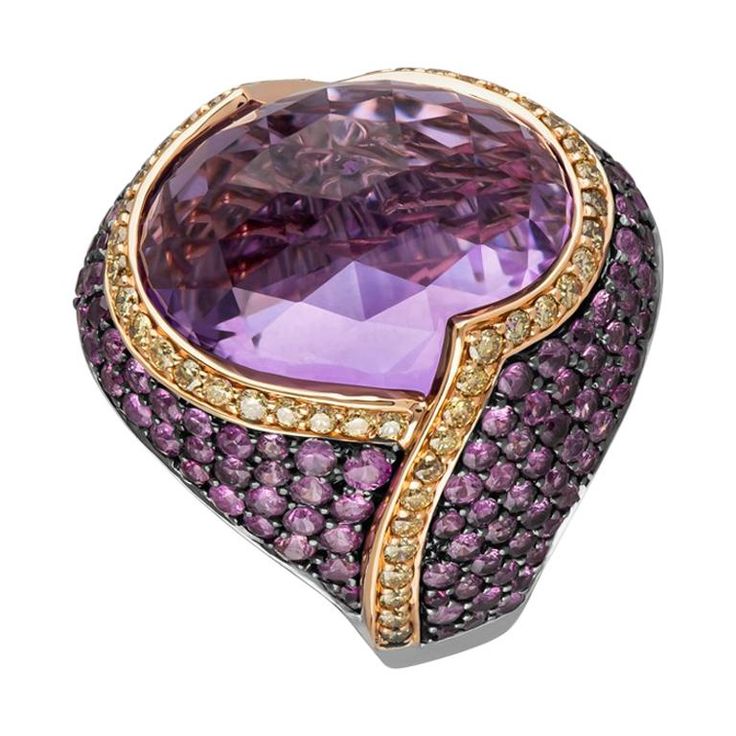 Dubbed the lion-heart ring due to its brave and inimitable style, this bold and beautiful piece centers around the main 20.63 carats undulating Amethyst Quartz gem. This amethyst is edged with a yellow gold and 0.63 carats of White Diamond trim before enveloping the finger in 2.82 carats worth of Pink Sapphires. Ring Size 7.25 This ring, as with all Zorab Creation pieces, is sent with a unique serial number to validate its authenticity. Unconventional Bride, Amethyst Cocktail Ring, Victorian Ring, Amethyst And Diamond Ring, Victorian Rings, Fancy Diamonds, Brown Diamond, Domed Ring, Amethyst Quartz