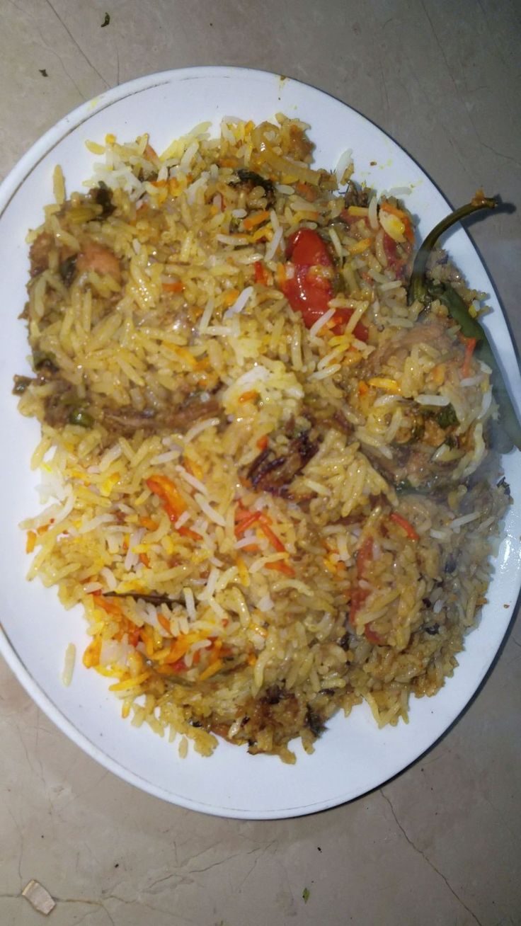 a white plate topped with rice and vegetables