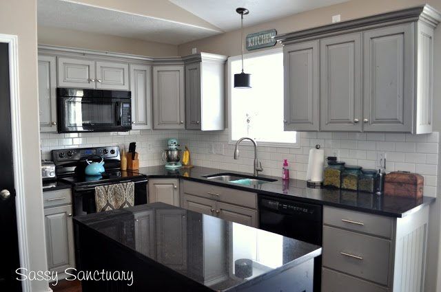 a kitchen with stainless steel appliances and black counter tops