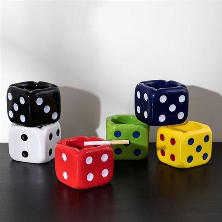 four different colored dices sitting on top of a table