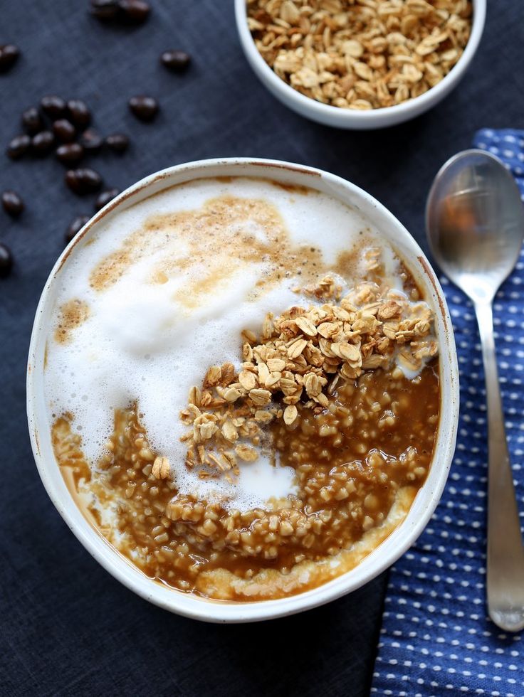 a bowl filled with oatmeal and granola on top of a blue napkin