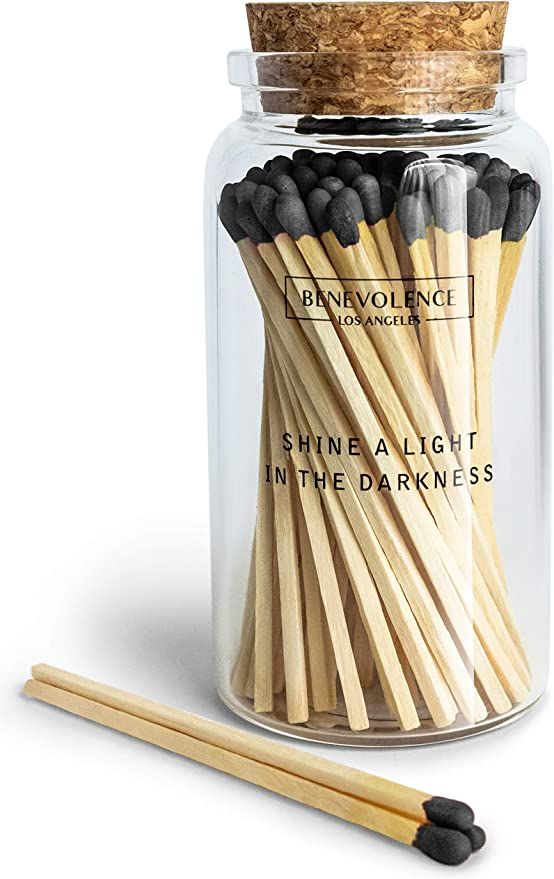 a jar filled with matches and two sticks