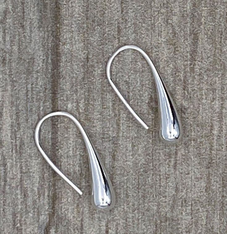 Elegant, elongated loop through polished silver teardrop earrings 1.25" long Classic Sterling Silver Teardrop Earrings, Modern Teardrop Dangle Earrings With French Hook, Classic Silver Teardrop Earrings, Modern Sterling Silver Teardrop Pendant Earrings, Sterling Silver Long Drop Teardrop Earrings For Formal Occasions, Classic Silver Teardrop Pendant, Minimalist Long Drop Teardrop Earrings For Formal Occasions, Minimalist Teardrop Drop Earrings For Formal Occasions, Formal Polished Long Drop Teardrop Earrings