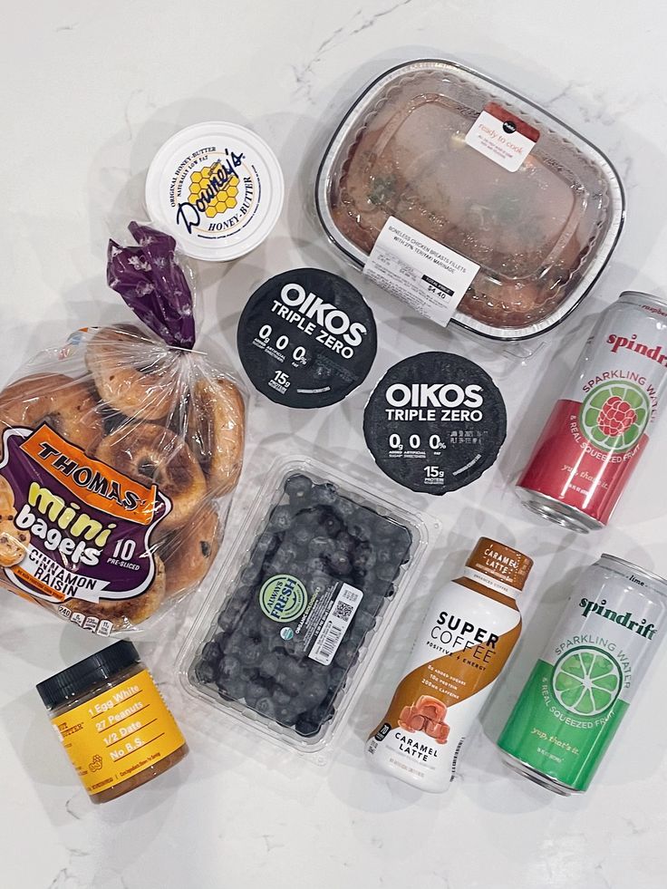 an assortment of food items sitting on top of a white counter next to each other