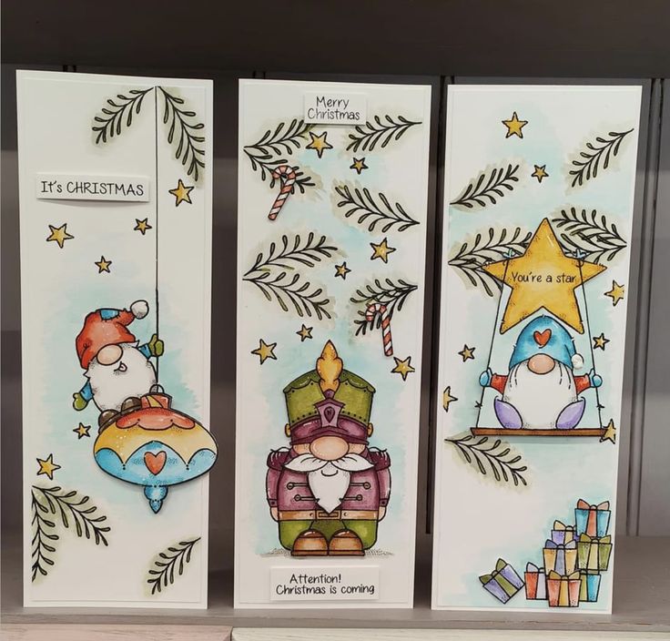 three christmas cards on display in a store