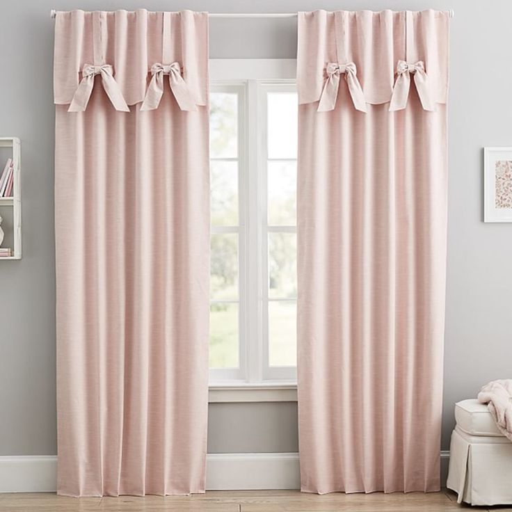 the curtains in this room are pink and have ruffles on top of them