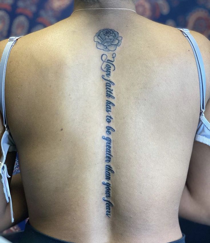 the back of a woman's upper body with an inscription on her left side