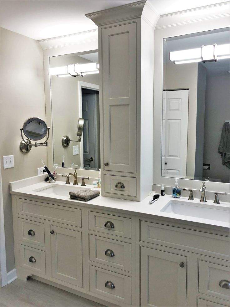 a large bathroom with double sinks and mirrors