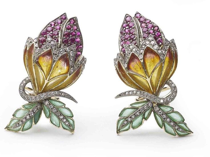 A pair of Moira bud earrings, with orange and yellow plique à jour enamel sepals and green leaves, with pavé set rubies and diamonds, mounted in gold, with silver settings. Numbered. Moira's eponymous collection was inspired by clients searching for unusual jewellery that just couldn't be sourced anywhere. Influenced by nature itself, Moira put together a collection representing the forms of flora and fauna, employing what are now rare traditional setting techniques, old-cut stones and enamel in Diamond Flower Earrings, Rubies And Diamonds, Moonstone Drop Earrings, Bijoux Art Nouveau, Diamond Cluster Earrings, Unusual Jewelry, Green Agate, Orange And Yellow, Diamond Flower