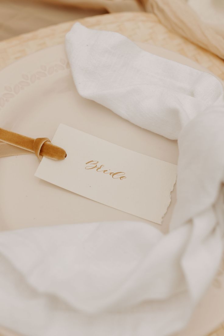 a table setting with napkins, fork and knife on the plate that says love