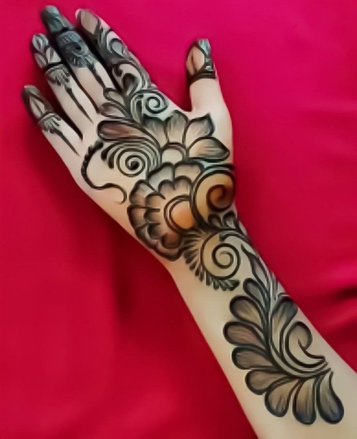 a woman's hand with hendix on it and flowers painted on the palm