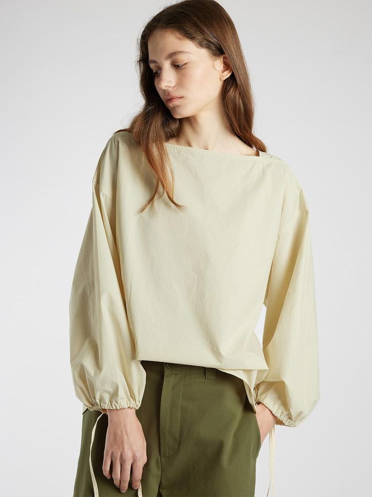 This is a modern and comfortable blouse by L’EAU that is made out of high quality fabric. With unique design detail and trendy mood, you can style it for your casual and young daily outfit.- Square neckline- Dropped shoulderline and wide armhole- Adjustable string on the sleeve- Natural volume fit Versatile Beige Long Sleeve Blouse, Versatile Long Sleeve Beige Blouse, Beige Long Sleeve Tops With Blouson Sleeves, Relaxed Fit Tops With Blouson Sleeves For Day Out, Spring Cotton Blouse With Elastic Shoulders, Spring Workwear Blouse With Elastic Shoulders, Spring Blouse For Workwear With Elastic Shoulders, Versatile Cream Long Sleeve Tops, Versatile Long Sleeve Cream Tops