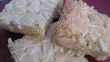 three pieces of white cake sitting on top of a purple plate next to each other