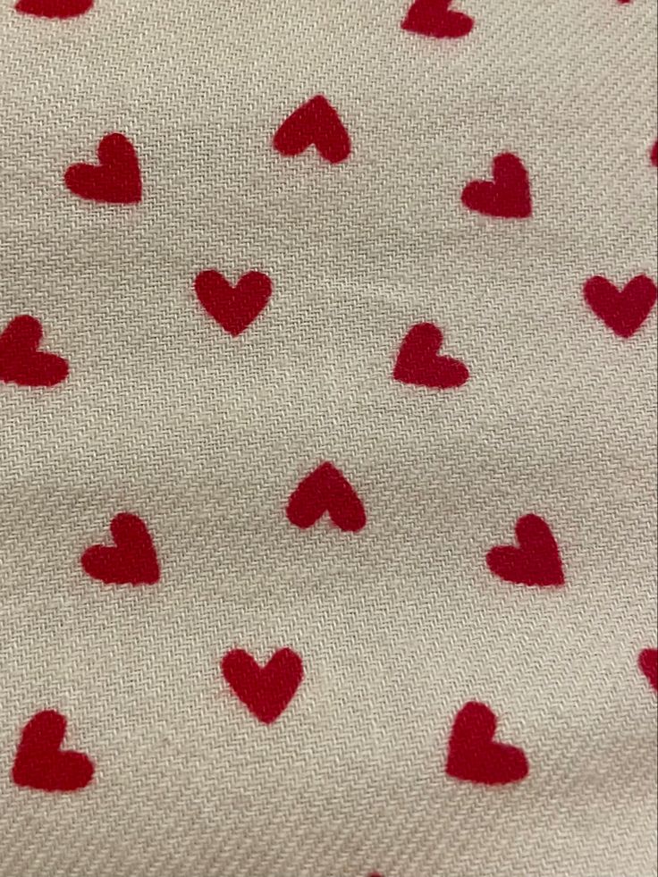 red and white hearts are on the fabric