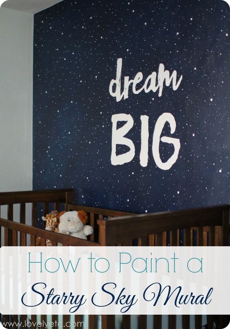 a baby crib with the words dream big painted on it and a teddy bear