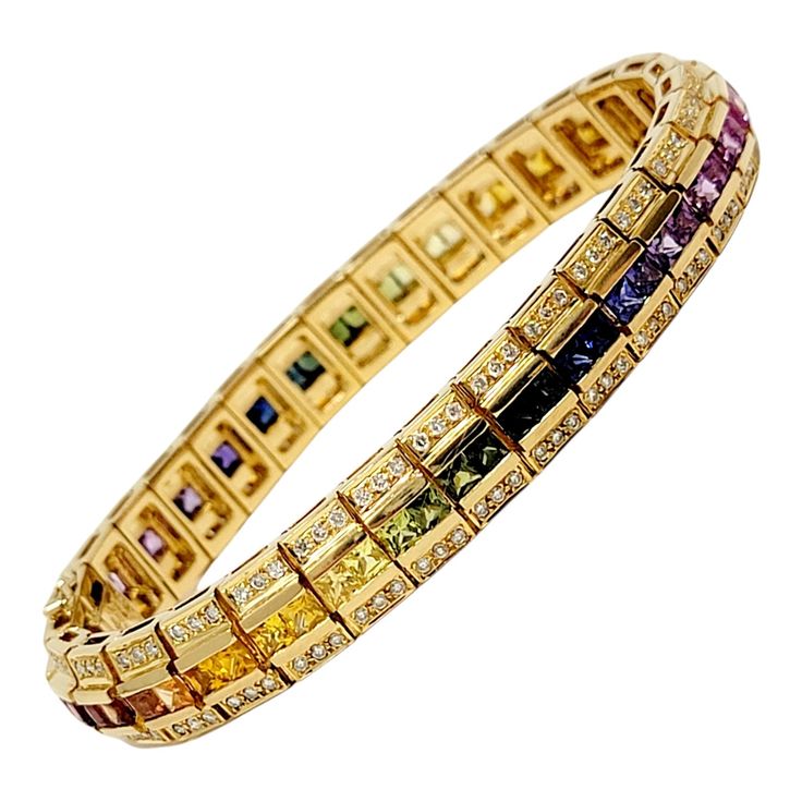 Incredible pave diamond and "rainbow" sapphire bracelet fills your wrist with vibrant color and charm. This unique kaleidoscopic piece features a variety of vivid hues that create a stunning rainbow ombre effect, while the sparkling diamonds glitter from all angles. This colorful 18 karat yellow gold link bracelet features an impressive 7.80 carats total of sparkling natural corundum sapphire stones in various shades of the rainbow. The square shaped sapphires are channel set in a single row and the gemstone colors fade from one color to the next, creating a breathtaking ombre design. Along the outer edges of the bracelet are 1.50 carats of natural round diamonds, G-H in color and SI1-SI2 in clarity, adding a bright, shimmering element to the already sparkly piece. It has a locking push cl 1st Dibs, Rainbow Ombre, Sapphire Stones, Rainbow Sapphires, Gold Link Bracelet, Jewelry Appraisal, Gold Link, Diamond Glitter, Sapphire Bracelet