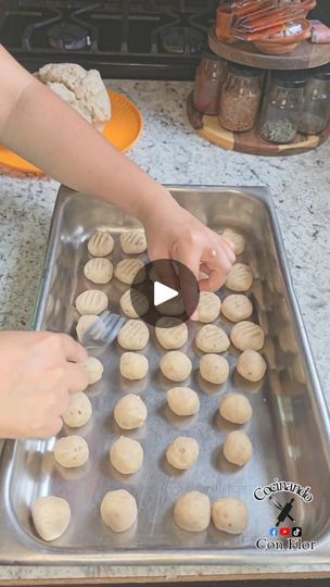 a person is making cookies on a pan