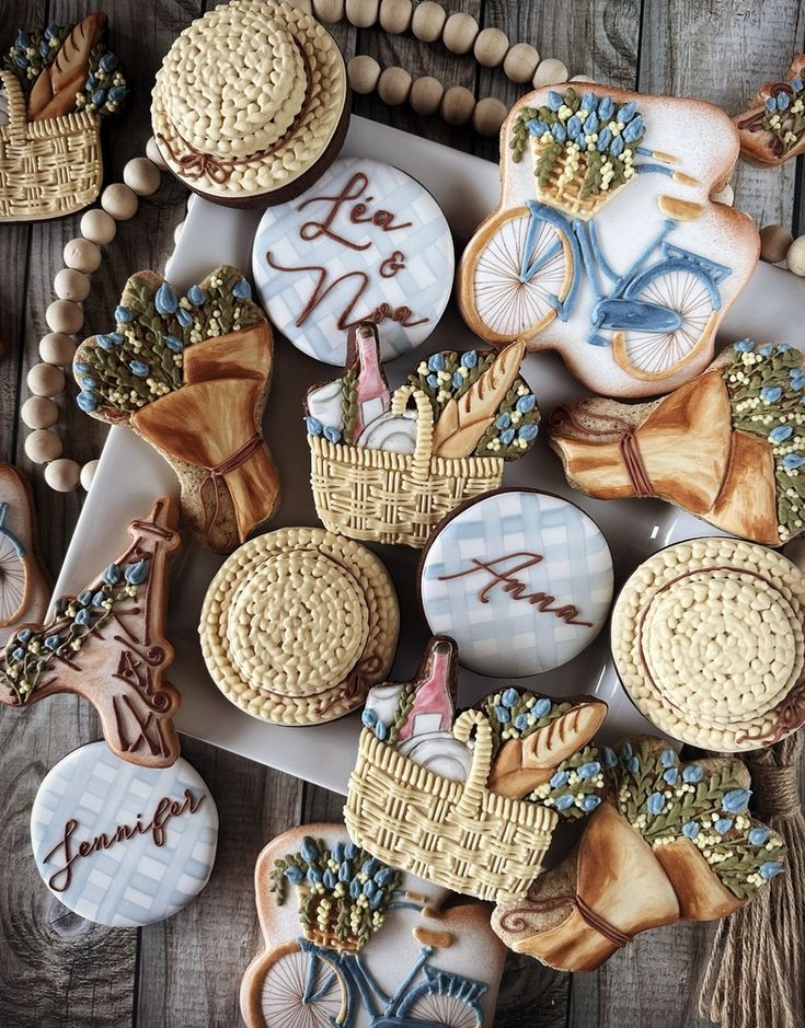 decorated cookies are displayed on a plate with beads and bead necklaces around them