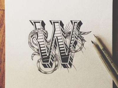 a drawing of the letter w on top of a piece of paper next to a pen