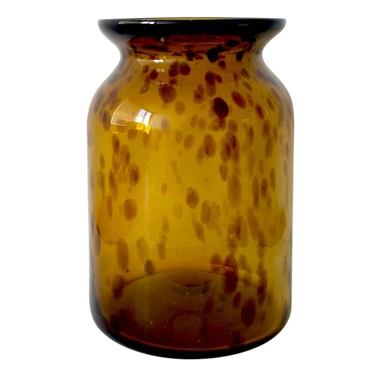 a yellow vase with brown spots on it