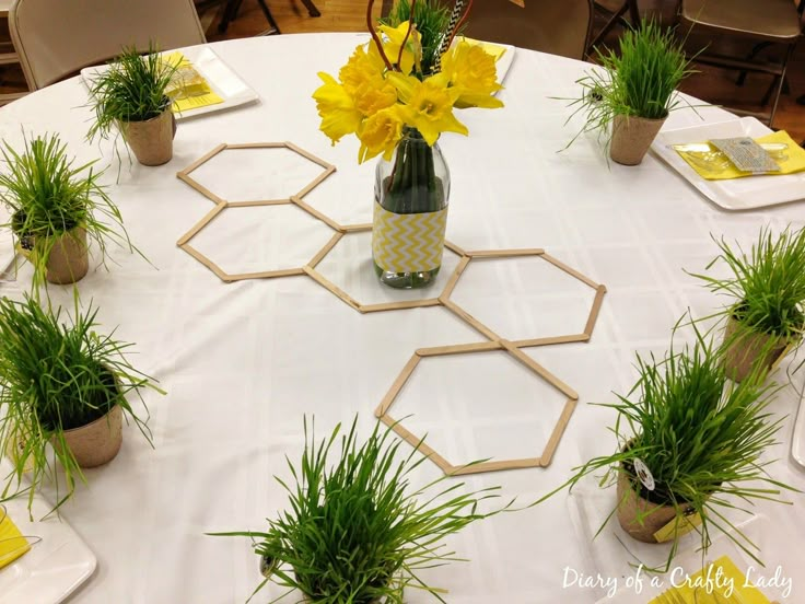 a table topped with vases filled with yellow flowers