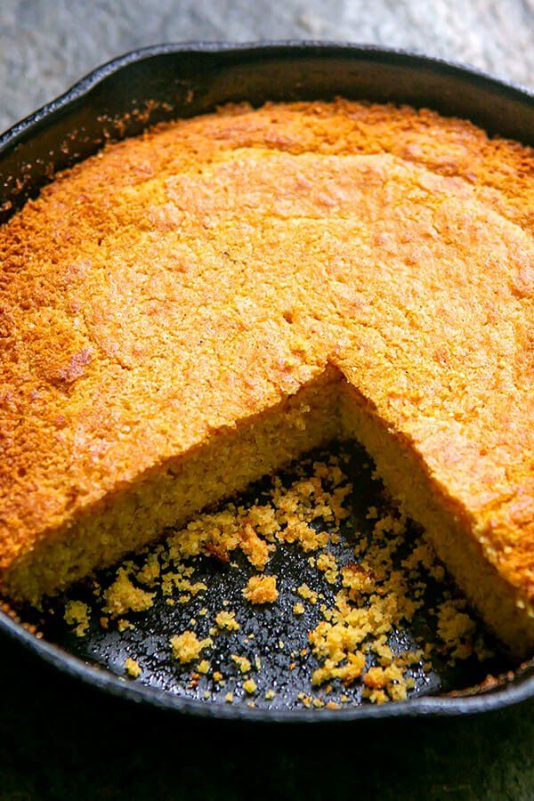 a cake in a pan with one slice cut out and ready to be served on the table